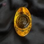 Golden Feng Shui wealth ingot placed on black satin cloth